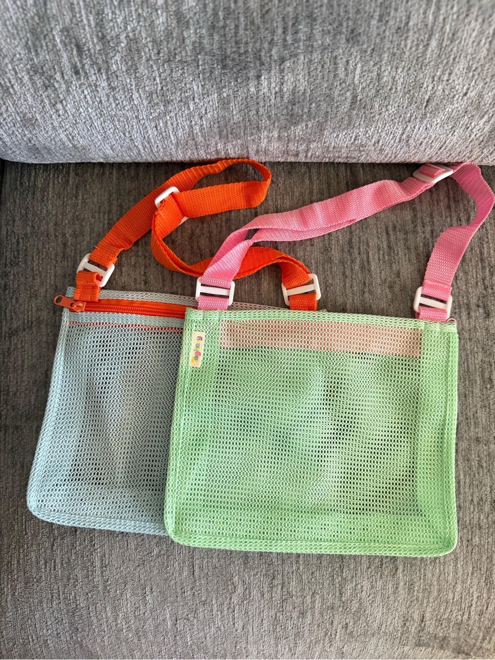 kids' mesh beach bags, adjustable straps & top zippers for collecting shells.